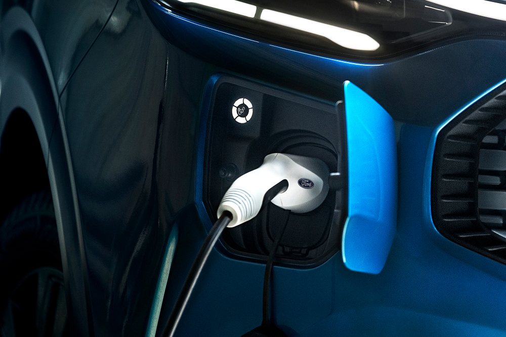 Een close-up van het ‘E’-logo op de grille van de elektrische Ford E-Transit Custom-bestelwagen. 