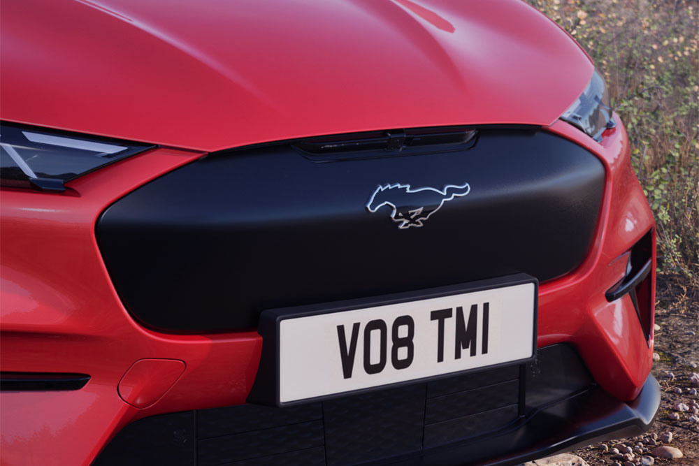 Close-up van de voorbumper van een Mustang Mach-E GT Rally in Race Red.