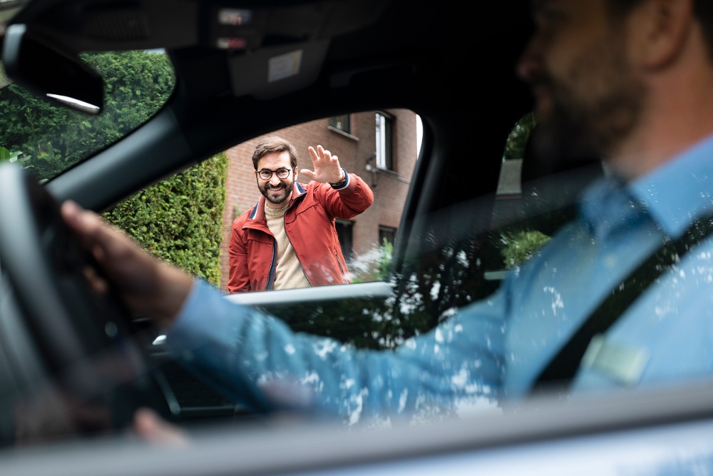 Keys being passed from a Ford representative to a customer